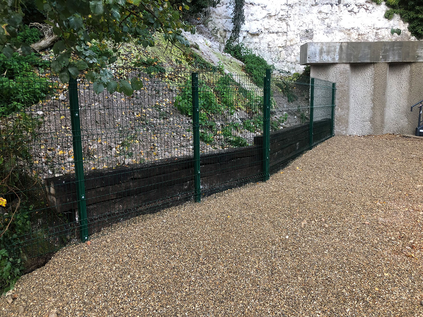 V-mesh with sleeper retaining wall by Vincent Fencing